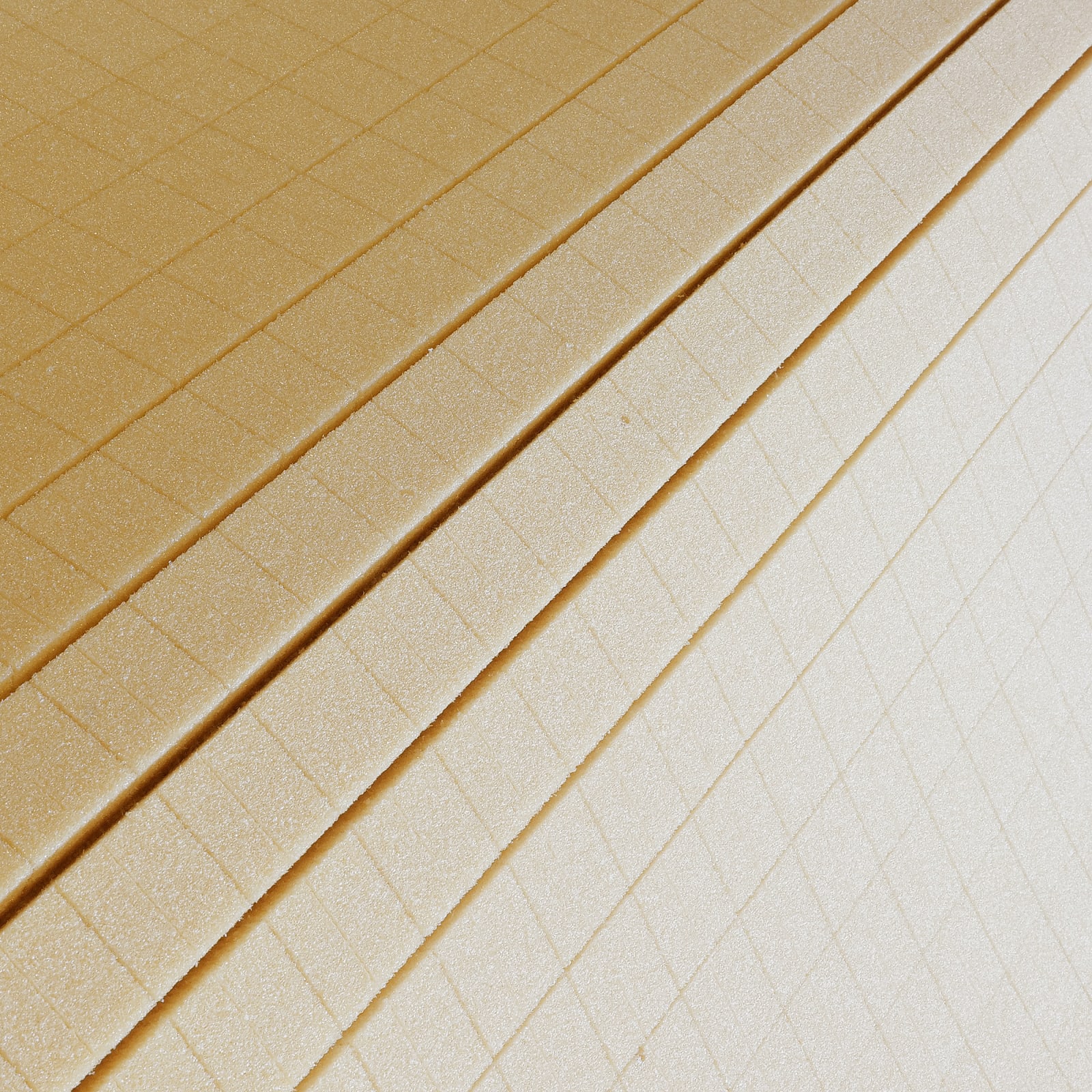 The image shows a close-up view of stacked wafer sheets with a grid pattern. The wafers have a light brown color and a textured surface.