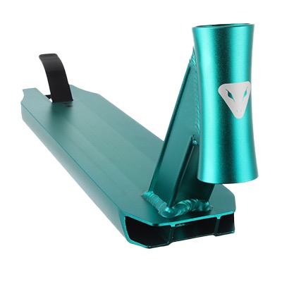 The image shows a teal-colored scooter deck with a head tube. The head tube has a logo resembling a stylized face or mask. The deck is metallic with a glossy finish and a brake attached at the rear.