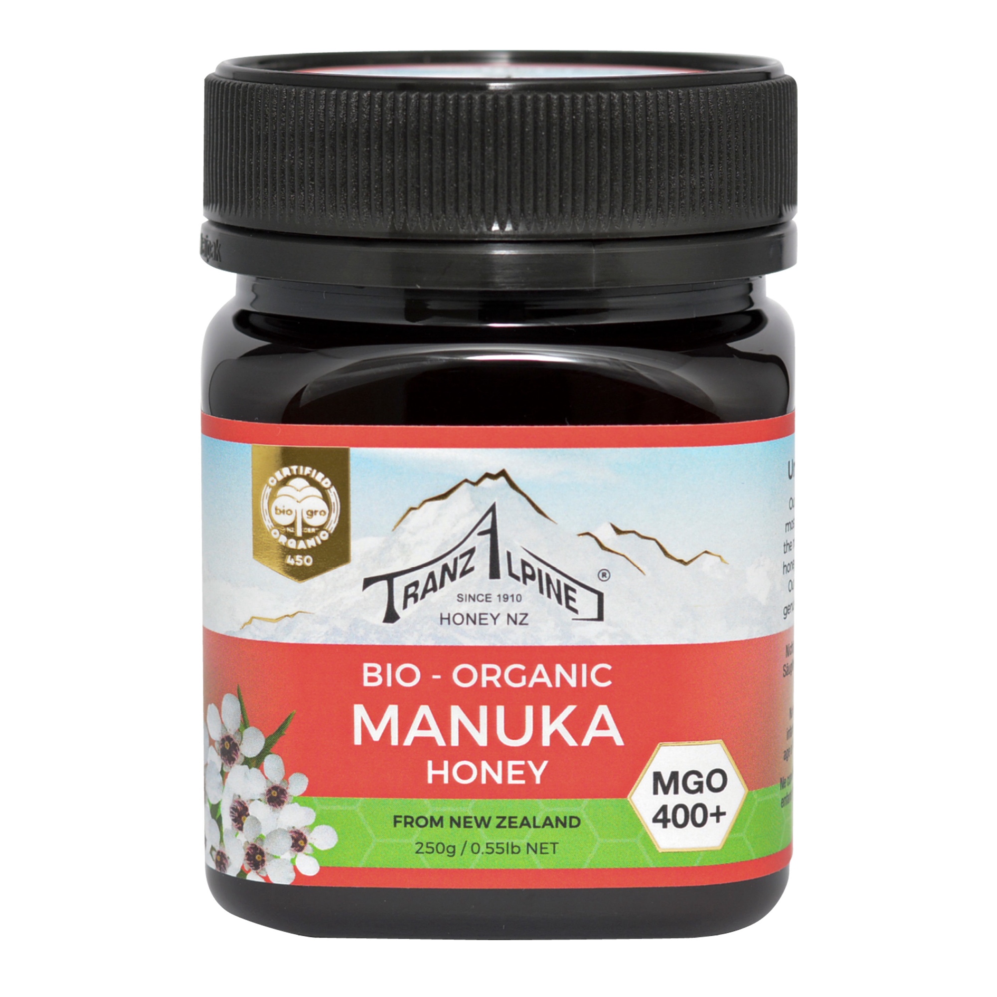 Produktfoto: Ein Glas Bio-Manuka-Honig der Marke TranzAlpine ist abgebildet. Das Etikett zeigt ein Bergmotiv und die Aufschrift 'Bio-Organic Manuka Honey MGO 400+ aus Neuseeland'. Der Honig ist in einem dunklen Glas mit schwarzem Deckel verpackt.