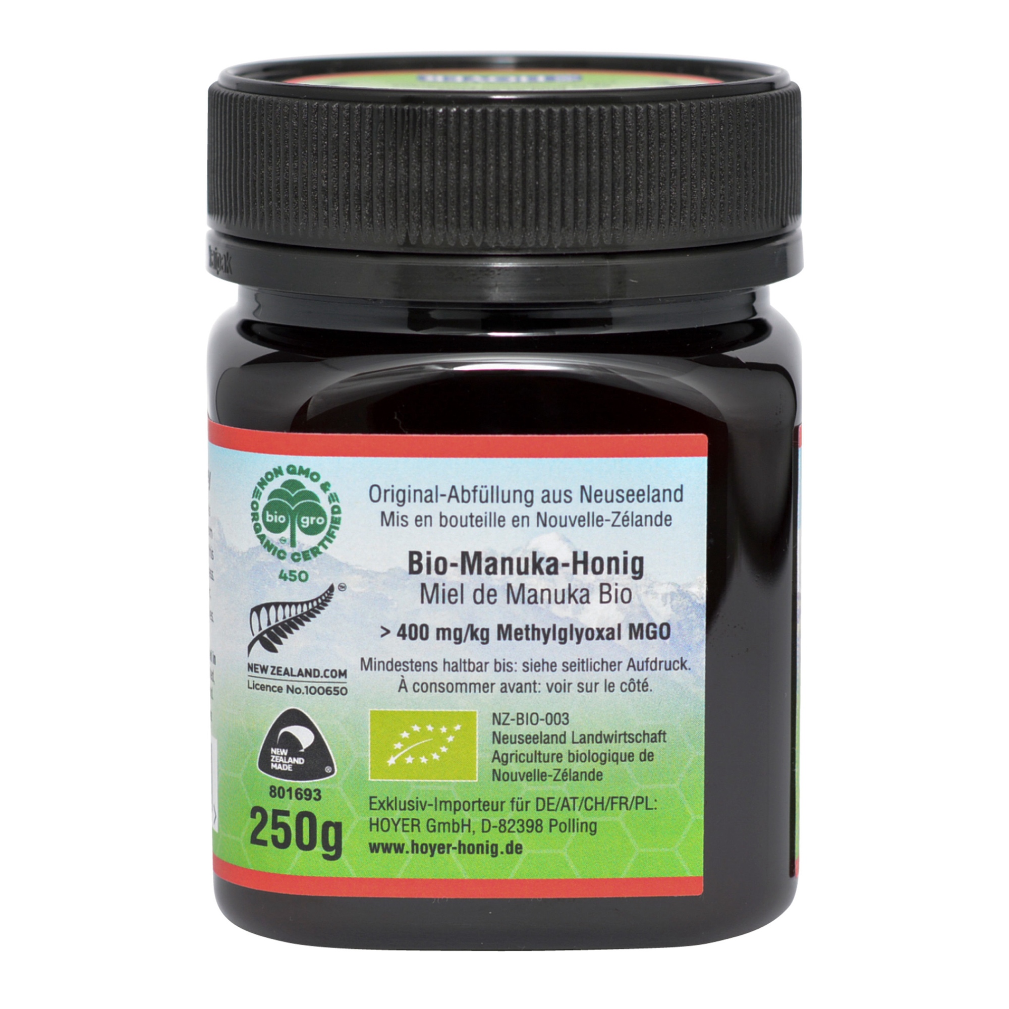 Produktfoto: Ein Glas Bio-Manuka-Honig der Marke TranzAlpine ist abgebildet. Das Etikett zeigt ein Bergmotiv und die Aufschrift 'Bio-Organic Manuka Honey MGO 400+ aus Neuseeland'. Der Honig ist in einem dunklen Glas mit schwarzem Deckel verpackt.