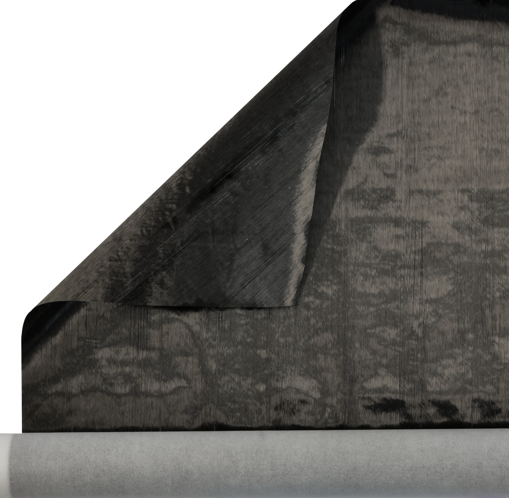 A close-up of a partially unrolled black sheet, possibly a fabric or paper, with a visible texture and a grayish roll underneath.
