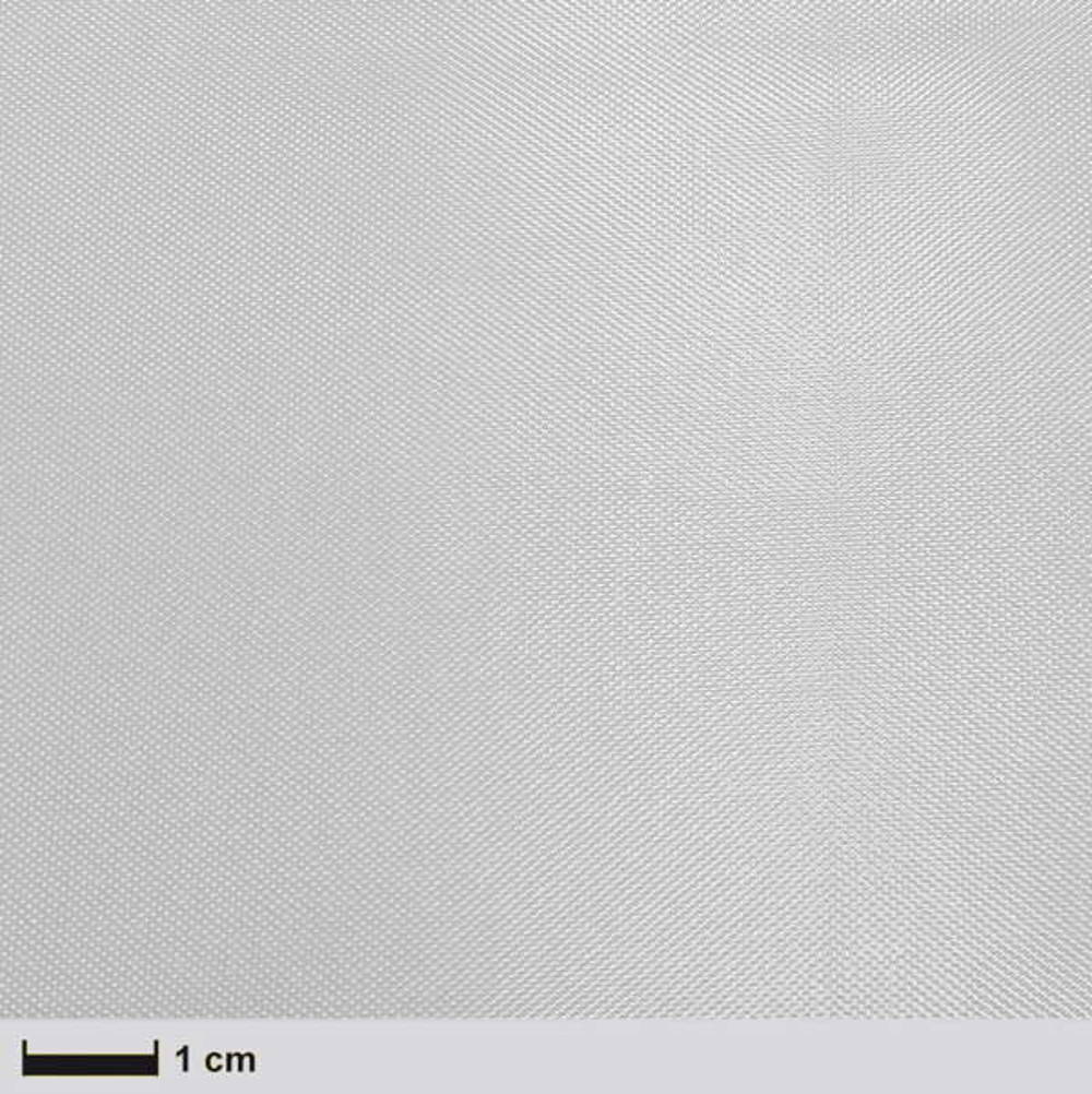 Nahaufnahme eines weißen, texturierten Materials mit feiner Struktur. Maßstabsleiste zeigt 1 cm an.