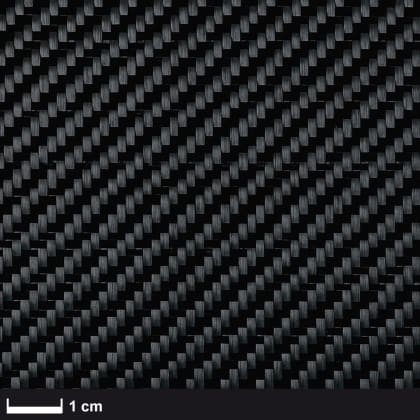 Nahaufnahme eines gewebten Kohlefaser-Musters mit Maßstab von 1 cm.