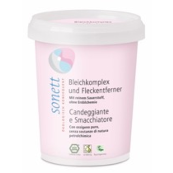 Produktfoto: Das Bild zeigt einen weißen Behälter mit rosa Etikett der Marke Sonett. Auf dem Etikett steht 'Bleichkomplex und Fleckenentferner'. Der Behälter hat ein weißes, abnehmbares Oberteil. Auf dem Etikett sind auch Logos für ökologische Zertifizierungen sichtbar.